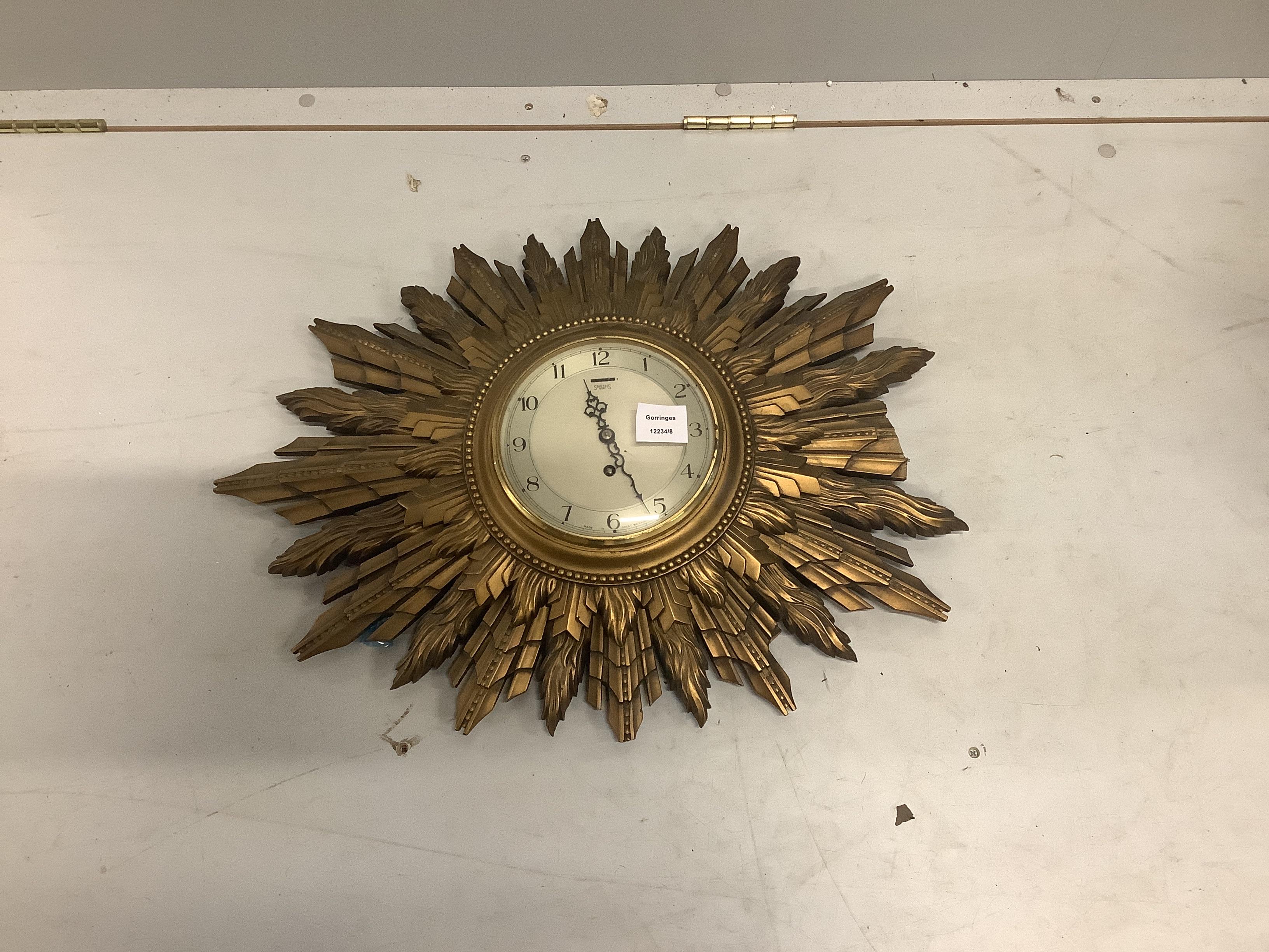 A Smith's electric sunburst wall timepiece, width 64cm, height 48cm (a.f.)